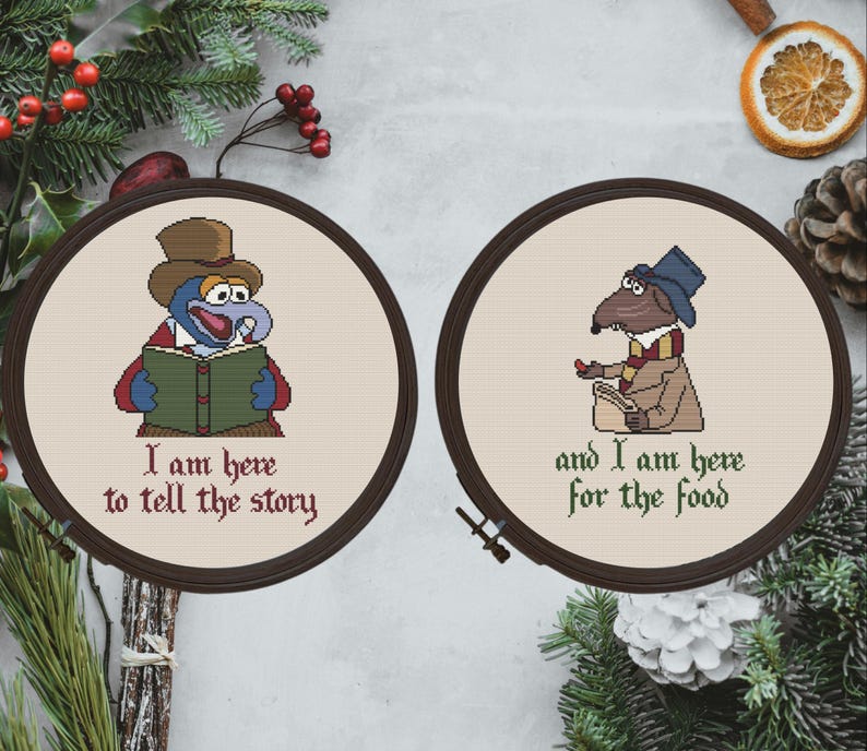 May include: Two embroidered hoop art pieces with a blue and red character holding a book and the text "I am here to tell the story" and a brown character holding a book and the text "and I am here for the food".