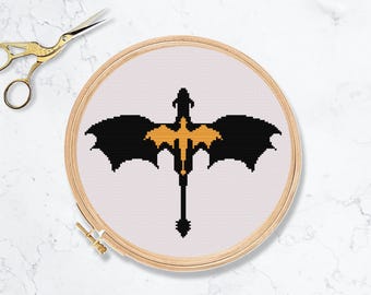 Motif dragon point de croix. Livre fantastique