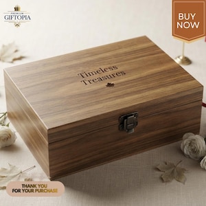 May include: A rectangular wooden keepsake box with a dark brown wood grain finish. The lid features the engraved text "Timeless Treasures" above a small maple leaf icon. A dark metal latch secures the front of the box lid to the base.