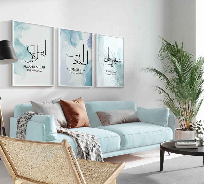 May include: Three framed prints with Arabic calligraphy and watercolor backgrounds. The prints feature the phrases "Allahu Akbar", "Alhamdulillah", and "Subhan Allah" in black calligraphy on a blue and white watercolor background.