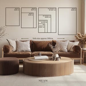 May include: A living room scene featuring a brown leather sofa with white and brown pillows, a round wooden coffee table, and a matching ottoman. Above the sofa, various framed art prints are displayed, with sizes ranging from 18x24 inches to 24x36 inches.