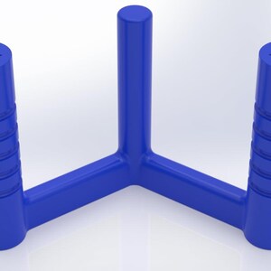 May include: A bright blue, three-pronged object with a central vertical cylinder and two outer vertical cylinders. The two outer cylinders feature horizontal ribbed detailing and a triangular opening at the top, while the central cylinder is smooth.