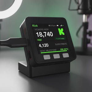 Puede incluir: Un dispositivo de visualización digital cuadrado de color negro para estadísticas de streaming sobre un soporte, conectado por un cable negro. La pantalla muestra el logo de Kick, 18.740 espectadores, 4.120 suscriptores y una barra de progreso.