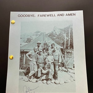 May include: A black and white photograph of a group of people standing in front of a tent. The photo is signed by the actor, Robert Guillaume. The photo is from the TV show "Goodbye, Farewell and Amen".