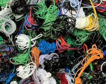 May include: A close-up of a tangled pile of colorful cords and strings. The cords are in various colors, including black, white, green, red, blue, and orange.