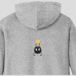 May include: Gray hooded sweatshirt with a black and yellow embroidered cartoon character on the back.