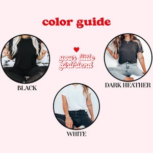 May include: A color guide featuring the text color guide and your little girlfriend with a red heart. Three circular images display t-shirts in black, dark heather, and white. Each shirt is shown worn with jeans or leggings, illustrating the available color options.