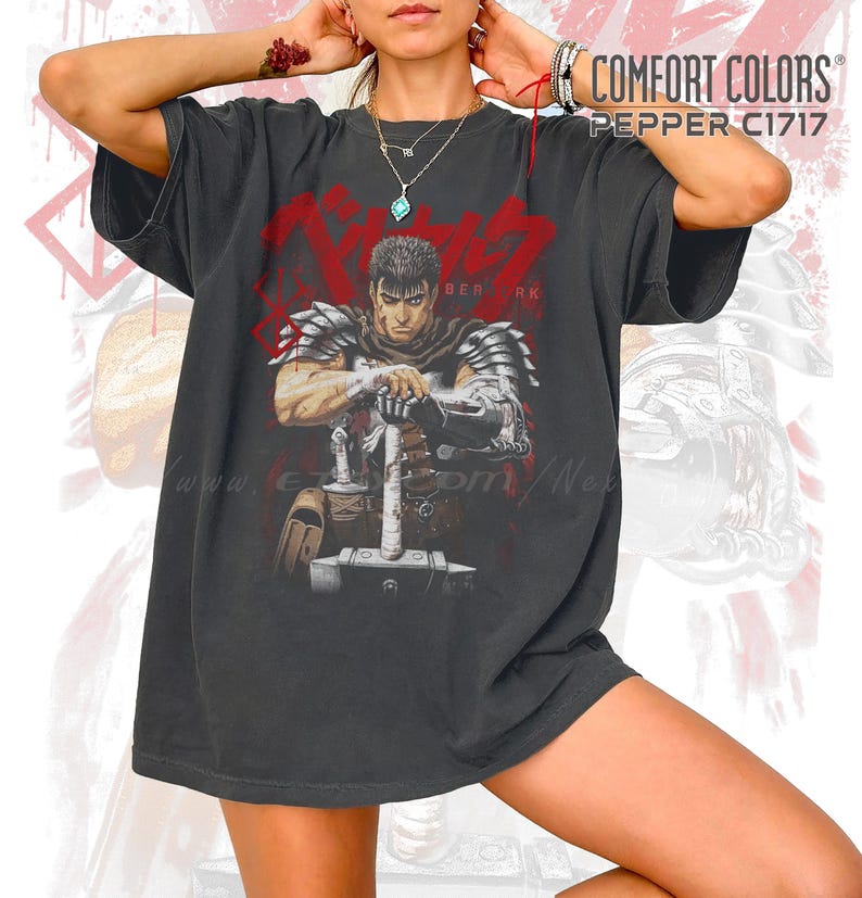 May include: Dark gray Comfort Colors t-shirt featuring a graphic of a warrior with a large sword, the word "BERSERK" in red, and the text "COMFORT COLORS PEPPER C1717". The shirt has a vintage, worn look.