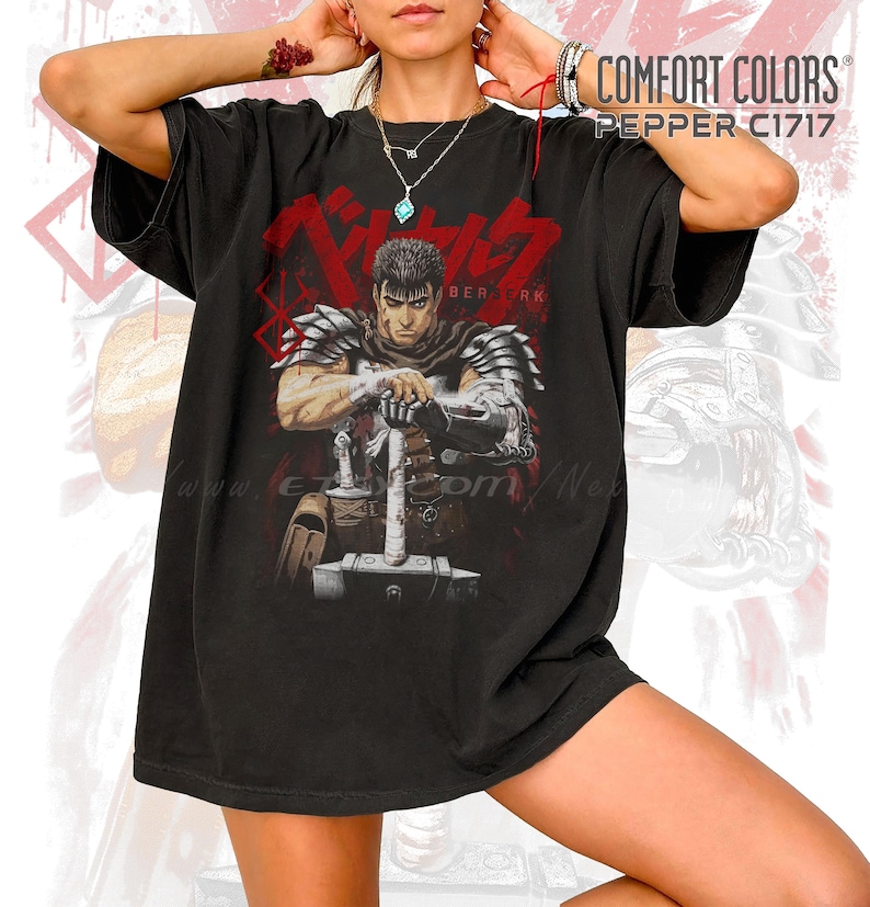 May include: Black Comfort Colors t-shirt featuring a graphic of a warrior with a sword, with the text "BERSERK" in red. The shirt has a vintage look and feel, with the text "COMFORT COLORS PEPPER C1717" printed on the upper right.