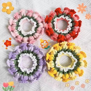 May include: Four crocheted hair scrunchies in different colors: pink, red, purple, and yellow. Each scrunchie is made of small flower-shaped knots and has a white crocheted trim.