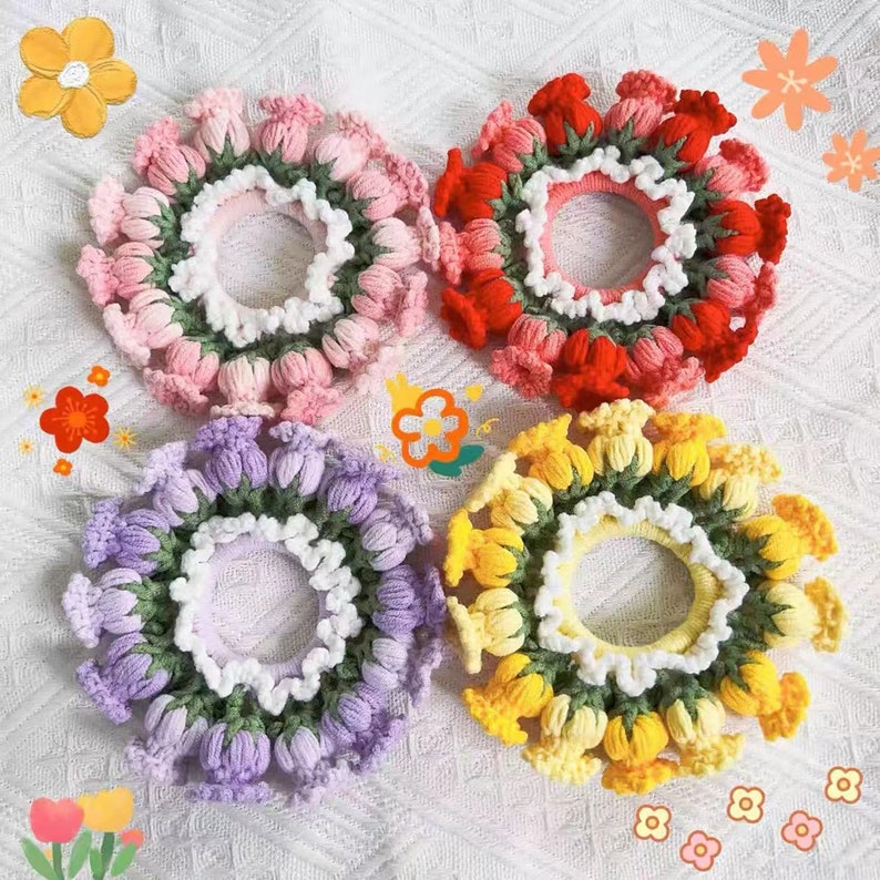 May include: Four crocheted hair scrunchies in different colors: pink, red, purple, and yellow. Each scrunchie is made of small flower-shaped knots and has a white crocheted trim.
