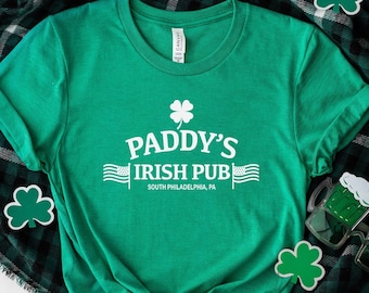 May include: Green t-shirt with white text that reads "Paddy's Irish Pub" and "South Philadelphia, PA". A shamrock is above the text.