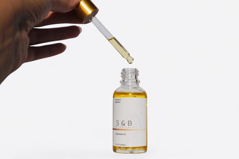 Close up of calendula infused oil showing golden color and texture