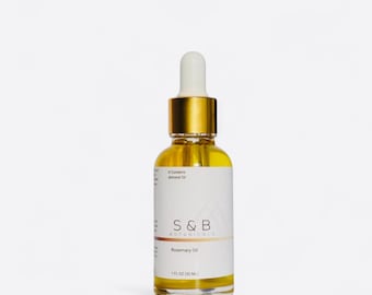 May include: A glass bottle with a gold cap and dropper filled with a yellow liquid. The bottle label reads "S&B Botanicals Rosemary Oil 1 FL OZ (30 ML)".