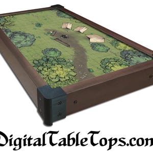 May include: A rectangular tabletop with a detailed green map design, featuring trees, tents, and a road. The tabletop has a dark brown wooden frame with black corner protectors. The text "DigitalTableTops.com" is at the bottom.
