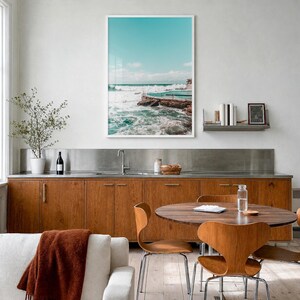 Bronte Beach Ocean Pool Fine Art Photo Print, sydney poster, full image (no border) in a white wood frame, hanging in a kitchen with a dining area