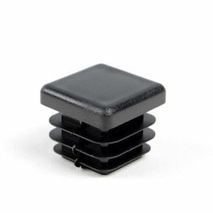 May include: Black plastic square furniture leg cap with a ribbed design.