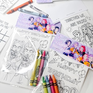 May include: A collection of coloring pages and crayons. The coloring pages feature line art illustrations with the text "HAPPY BIRTHDAY TO YOU" and "TOGETHER WE ARE GOLDEN". Several packs of Crayola crayons in various colors are also visible.