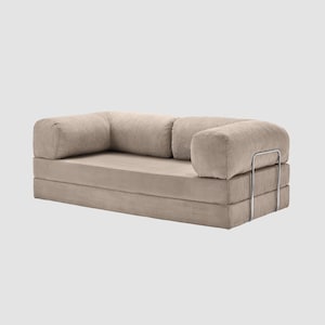 May include: A beige corduroy sofa with rounded armrests and a low profile. The sofa has a modular design with a metal support frame. The fabric has a ribbed texture, and the overall aesthetic is modern and minimalist.