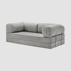 May include: A set of three ceramic mugs with a speckled, matte finish. The mugs are in shades of cream, light gray, and dark gray. Each mug has a simple, minimalist design, perfect for coffee or tea.