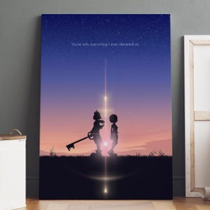 May include: A framed print featuring a silhouette of two figures standing on a hill, with a key-shaped weapon. The background shows a gradient sky with stars and the text "You're only everything I ever dreamed of."