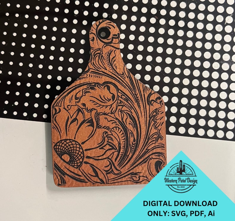 May include: A brown leather cutout with a black floral design. The cutout is shaped like a cattle ear tag. The text "Western Petal Design Est. 2023" is in the lower right corner of the image. DIGITAL DOWNLOAD ONLY: SVG, PDF, Ai