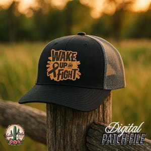 May include: Black and grey trucker hat with a brown leather patch that says "Wake Up and Fight" with a black ribbon.