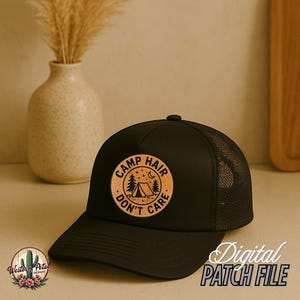 May include: Black trucker hat with a brown leather patch that says "Camp Hair Don't Care" with a tent and trees inside the circle.