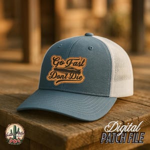 May include: A blue and white trucker hat with a brown leather patch that says "Go Fast Don't Die" with a car silhouette.