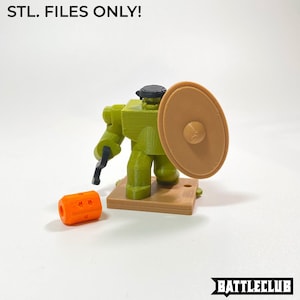 May include: A green and brown 3D printed miniature figure holding a sword and a shield. The figure is standing on a brown base. STL. FILES ONLY! is written in white text at the top of the image.