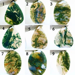 May include: Nine moss agate gemstones in different shapes. Each stone features unique patterns of green, brown, and white, reminiscent of natural landscapes. The gemstones are shown against a white background.