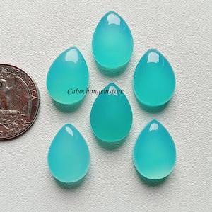 May include: Six teardrop-shaped turquoise cabochon gemstones. The gemstones are approximately the size of a US quarter.