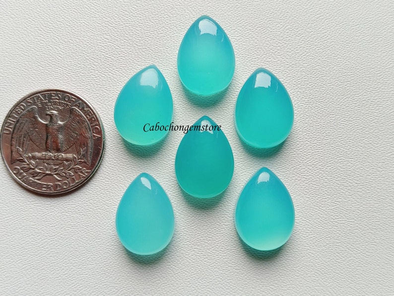 May include: Six teardrop-shaped turquoise cabochon gemstones. The gemstones are approximately the size of a US quarter.