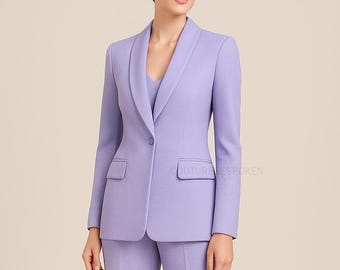 May include: A light purple women's suit featuring a tailored blazer with a shawl collar and a single-button closure. The suit includes a matching top and pants, creating a coordinated ensemble. The blazer has two front pockets.