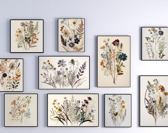 May include: A collection of 10 framed botanical prints featuring pressed flowers and leaves in various colours and arrangements. The prints are displayed on a pale blue wall.