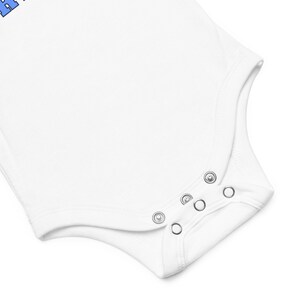 Close up of snaps on white onesie. Lil Tarheel Baby short sleeve one piece | Lil Tarheel Onesie | Team Mascot | Newborn | School Spirit. On white background.
