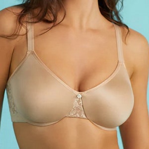 May include: A nude-colored underwire bra with adjustable straps and a lace trim. The bra has a smooth, seamless cup and a center front closure.