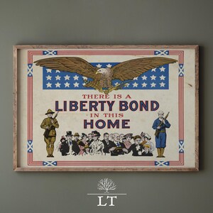 May include: Vintage framed print with a patriotic theme. The artwork features a brown eagle with outstretched wings above a blue field of white stars. The text reads "THERE IS A LIBERTY BOND IN THIS HOME."