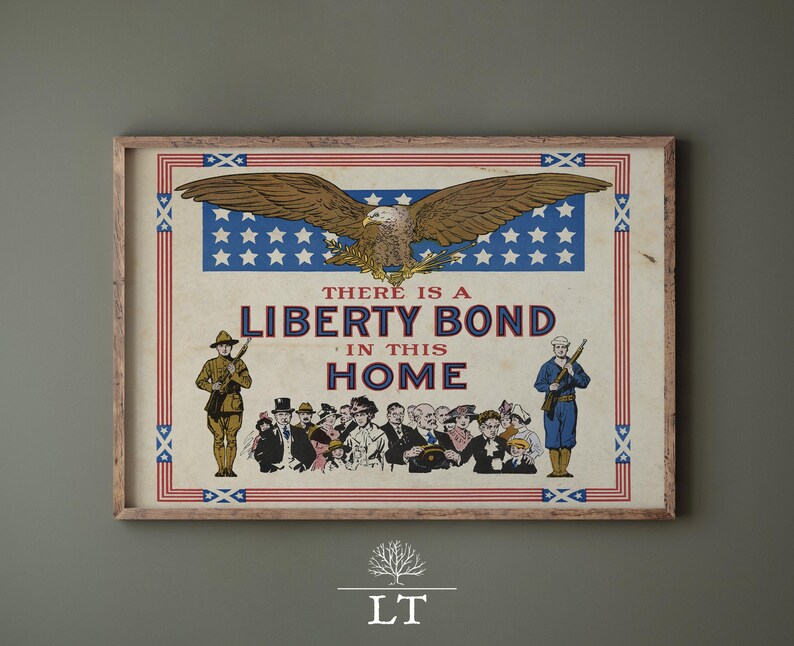 May include: Vintage framed print with a patriotic theme. The artwork features a brown eagle with outstretched wings above a blue field of white stars. The text reads "THERE IS A LIBERTY BOND IN THIS HOME."