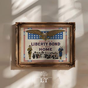 May include: Framed vintage print with a patriotic theme. The artwork features an eagle, stars, and the text "THERE IS A LIBERTY BOND IN THIS HOME." Soldiers and a crowd of people are also depicted. The frame is ornate and brown.