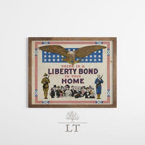 May include: Framed vintage print with a patriotic theme. The artwork features a soaring eagle above text that reads "THERE IS A LIBERTY BOND IN THIS HOME." Two soldiers stand on either side of a crowd of people. The frame is brown.