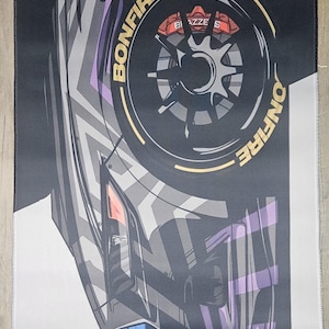 May include: Black and white mousepad with a car wheel graphic. The wheel has red brake calipers and the word "BONFIRE" in gold. The mousepad also features the text "EDC" and Japanese characters.
