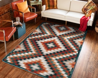 May include: A geometric patterned rug with a white background and orange, green, and blue accents. The rug is laid out on a wooden floor in a living room setting.