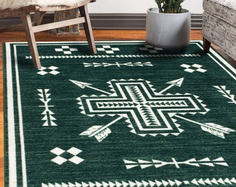 May include: A green and white area rug with a geometric pattern featuring arrows and a cross. The rug has a fringed border.