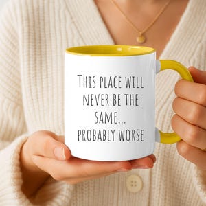 May include: A white ceramic mug with a bright yellow interior and handle. The exterior features black text that reads: This place will never be the same... probably worse. The mug has a smooth, glossy finish and a standard cylindrical shape.
