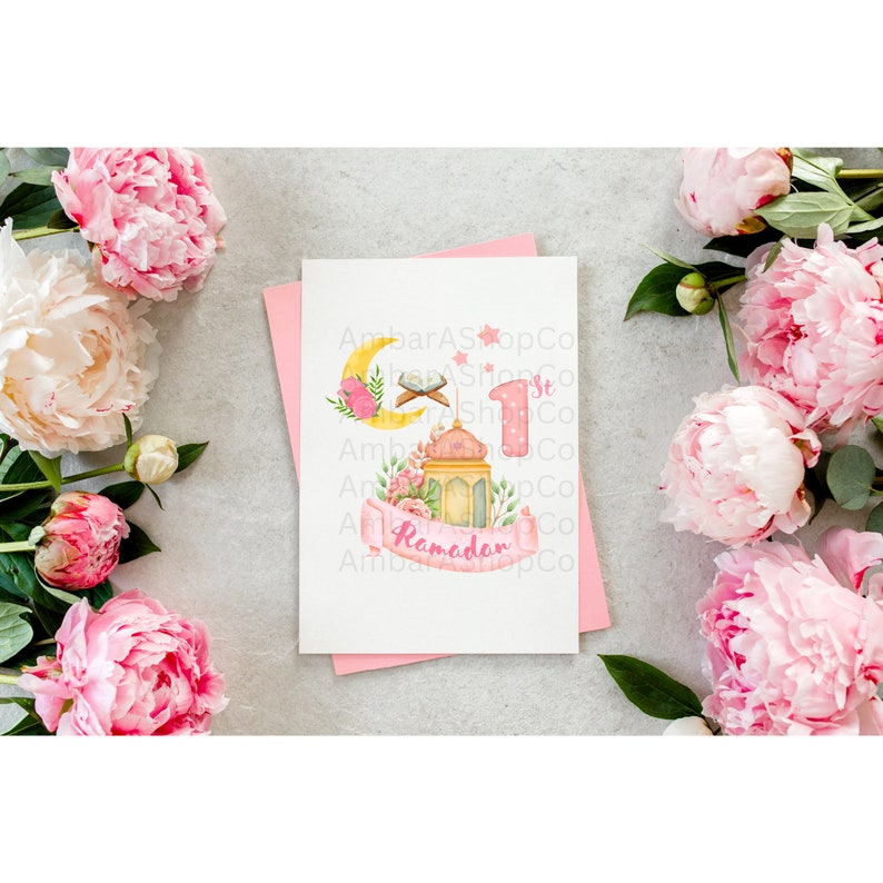 May include: A pink and white card with a crescent moon, a lantern, and a floral design. The card says "1st Ramadan".