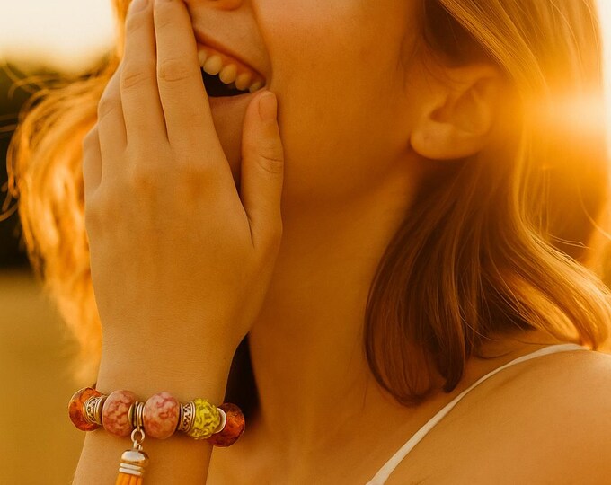 Bejeweled orange beaded bracelet w/ leather tassle