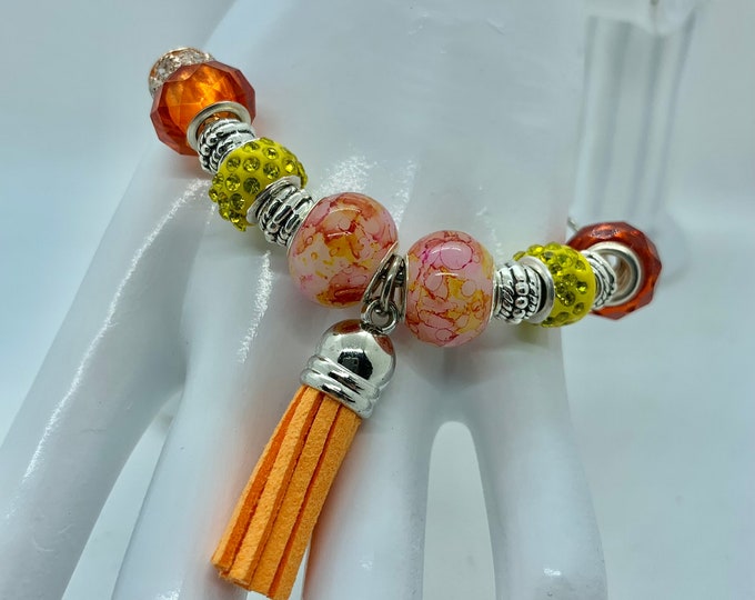 Bejeweled orange beaded bracelet w/ leather tassle