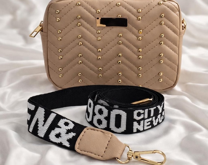 Beige quilted crossbody handbag with gold stud detailing and bold black “980” canvas strap