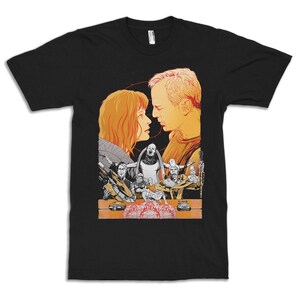 May include: Black t-shirt featuring a graphic print of a couple gazing into each other's eyes. The design also includes a scene from a film with several characters and vehicles.